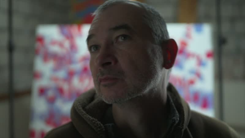 Tobias Post in his studio, a painting in the background